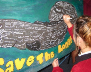 Students signing the banner